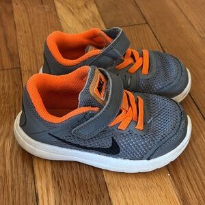 Nike Kid’s Sneakers in Gray and Bright Orange